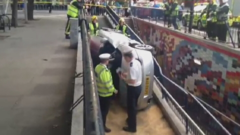 Car smashes through barrier into London subway